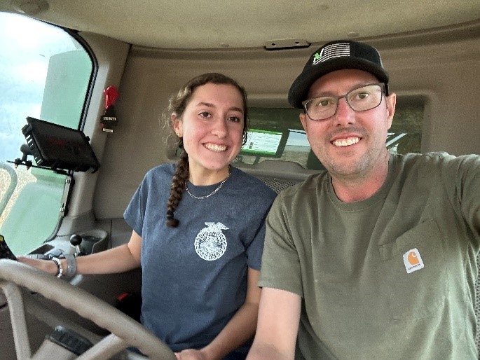 Student and Nutrien farmer in tractor