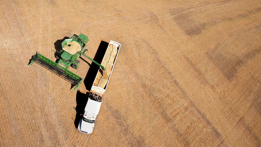 Drone photo of a truck being filled with grain